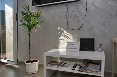 a white table with a laptop and a potted plant at Lola - New, best located, elegant & super tidy in Kotor