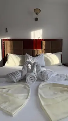 two towels on a bed in a hotel room at Apartmani Adelina in Donji Štoj