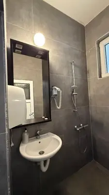 a bathroom with a sink and a mirror at Apartmani Adelina in Donji Štoj