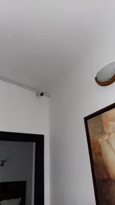 a room with a ceiling with a painting and a light at Apartmani Adelina in Donji Štoj