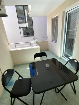 a black table and two chairs in a room at Apartmani Adelina in Donji Štoj