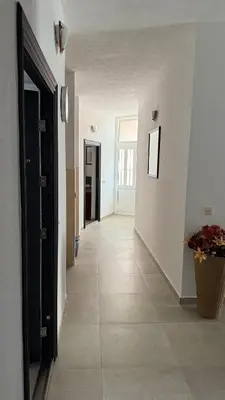 a hallway with white walls and a tile floor at Apartmani Adelina in Donji Štoj