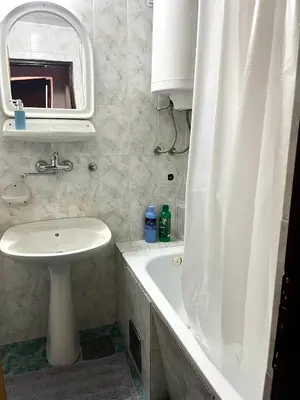 a bathroom with a sink and a tub and a toilet and a mirror at Apartment Rumi Sutomore in Sutomore
