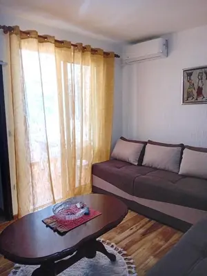 a living room with a couch and a coffee table at Apartment Rumi Sutomore in Sutomore