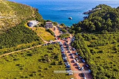 an aerial view of a parking lot next to the ocean at Apartment Rumi Sutomore in Sutomore