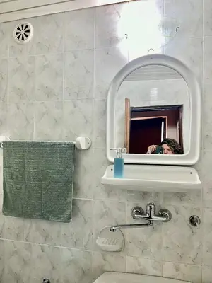 a person taking a picture in a bathroom mirror at Apartment Rumi Sutomore in Sutomore