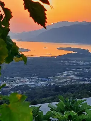 a view of a city and the ocean at sunset at Village House DIMS in Kotor