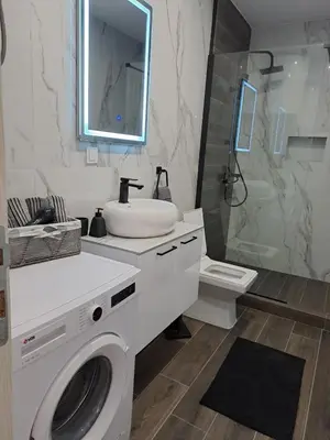 a white bathroom with a sink and a washing machine at Village House DIMS in Kotor