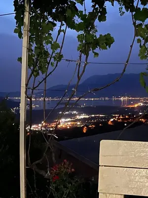 a view of a city at night with lights at Village House DIMS in Kotor