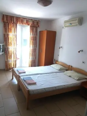 a bedroom with a large bed in front of a window at Mirko Apartments Budva in Budva