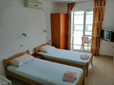 two beds in a room with a balcony at Mirko Apartments Budva in Budva
