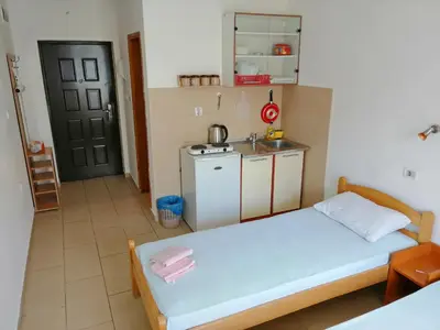 a small room with a bed and a kitchen at Mirko Apartments Budva in Budva