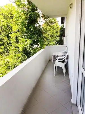 a balcony with a table and a chair on it at Mirko Apartments Budva in Budva