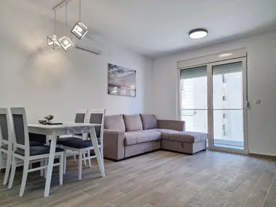 a living room with a couch and a table at MilLaz Apartman in Becici