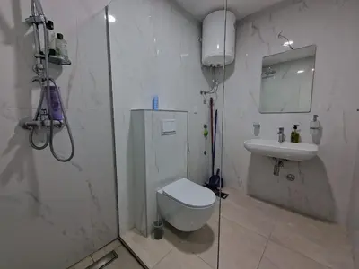 a bathroom with a shower and a toilet and a sink at MilLaz Apartman in Becici