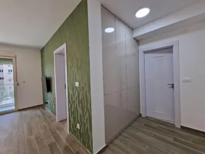 an empty room with a hallway with a door at MilLaz Apartman in Becici