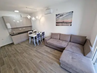 a living room with a couch and a table at MilLaz Apartman in Becici