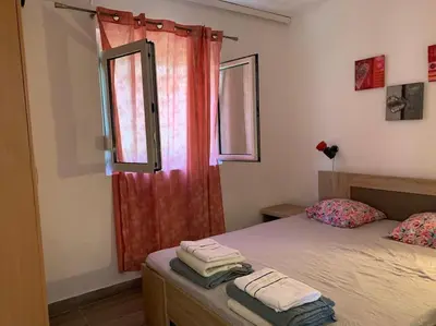 a bedroom with a bed and a window with towels at Kite paradise - Ground floor for 5, Velika plaza- Long Beach in Ulcinj