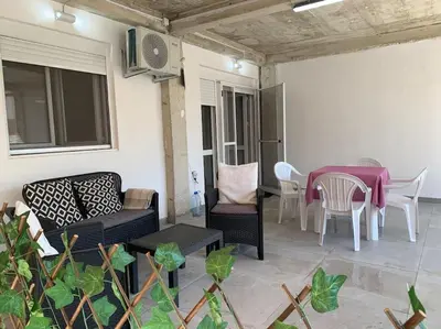 a patio with a table and chairs and a dining room at Kite paradise - Ground floor for 5, Velika plaza- Long Beach in Ulcinj