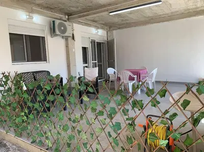 a fence in front of a house with chairs at Kite paradise - Ground floor for 5, Velika plaza- Long Beach in Ulcinj