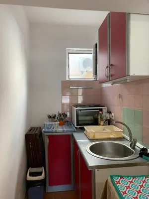 a small kitchen with a sink and a microwave at Kite paradise - Ground floor for 5, Velika plaza- Long Beach in Ulcinj