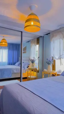 a bedroom with two beds and a large mirror at Centre Budva Green in Budva