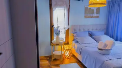 a bedroom with a bed with a mirror and a lamp at Centre Budva Green in Budva