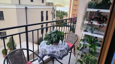 a table and chairs on a balcony with plants at Centre Budva Green in Budva