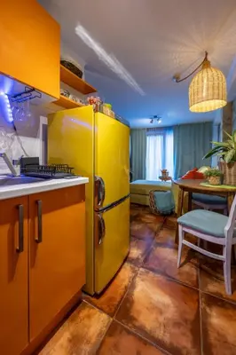 a kitchen with a yellow refrigerator and a table at Centre Budva Green in Budva