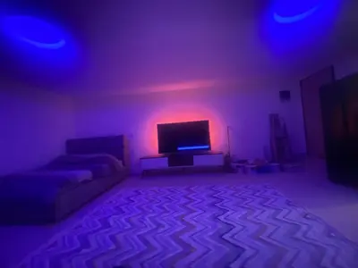 a living room with a tv and purple lights at Podgorica 23 in Podgorica