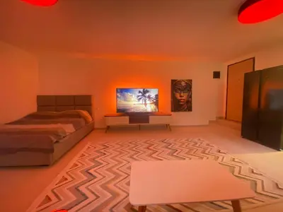 a bedroom with a bed and a table in it at Podgorica 23 in Podgorica