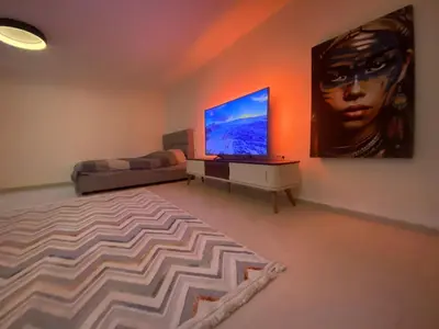 a living room with a flat screen tv and a couch at Podgorica 23 in Podgorica