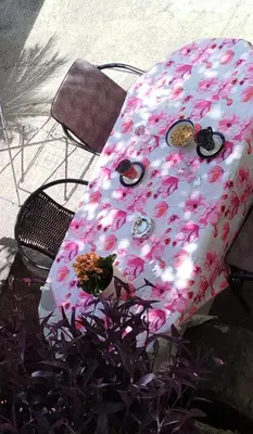 a table with a flowered table cloth with flowers on it at APARTMAN Biser in Kotor