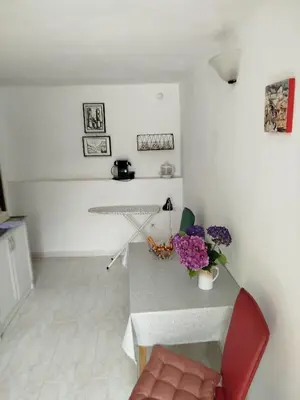 a living room with a table and a red chair at APARTMAN Biser in Kotor