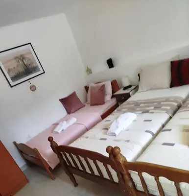 a bedroom with two beds and a couch at APARTMAN Biser in Kotor