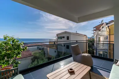 a balcony with a table and a view of the ocean at Royal Oasis Seaview - Sveti Stefan in Sveti Stefan