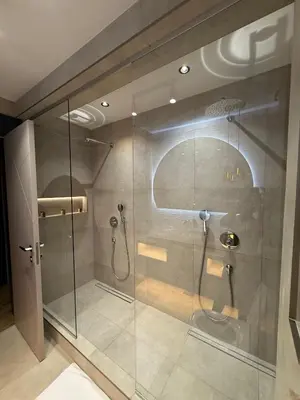 a bathroom with a shower with a glass door at Royal Oasis Seaview - Sveti Stefan in Sveti Stefan