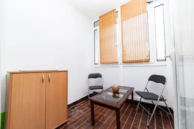 a room with two chairs and a table and a cabinet at Apartment Simanic in Budva