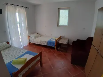 a small room with two beds and a couch at Vesna Apartments in Ulcinj