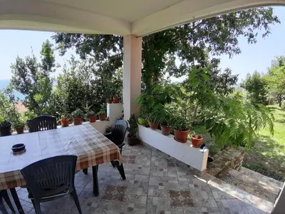 a patio with a table and chairs and plants at Vesna Apartments in Ulcinj