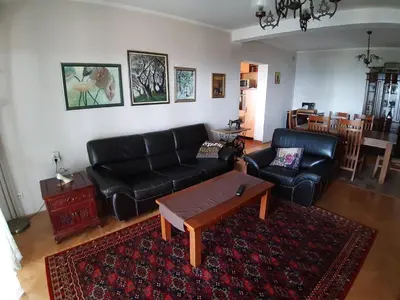 a living room with a black couch and a coffee table at Vesna Apartments in Ulcinj