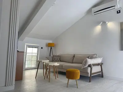 a living room with a couch and a table at Coastal Two Bedroom Comfort in Budva