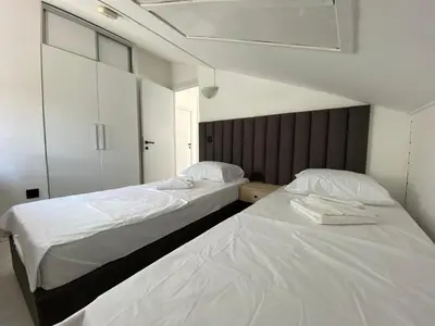 two beds sitting next to each other in a bedroom at Coastal Two Bedroom Comfort in Budva