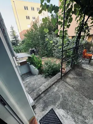 an outside view of a patio with a bench and plants at Garden Apartments Budva in Boreti