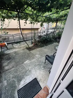 a patio with a bench and a fence at Garden Apartments Budva in Boreti