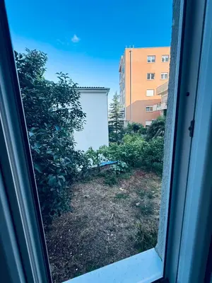 a view of a yard from a window at Garden Apartments Budva in Boreti