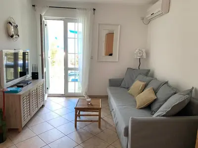a living room with a couch and a table at Apartment Oliva, Rafailovici in Budva