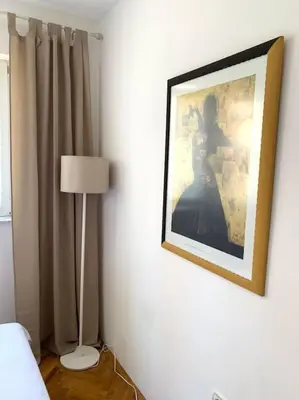 a bedroom with a picture of a woman on the wall at Apartment Oliva, Rafailovici in Budva