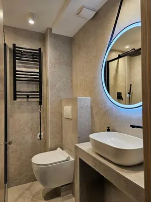 a bathroom with a sink and a toilet and a mirror at Apartment Oliva, Rafailovici in Budva