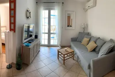 a living room with a couch and a tv at Apartment Oliva, Rafailovici in Budva